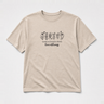 Where Acceptance Grows Love Blooms WildflowersTee Sand t-shirt, front