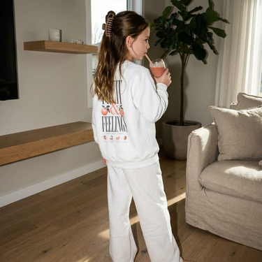 Model wearing the White Fruit & Feelings youth sweatshirt, back print