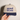 Close-up of the front print on the Navy and Natural Proud of You embroidered hat