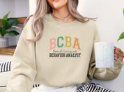 BCBA - Board Certified Behavior Analyst College Style Sweatshirt-Neurodiversity, ADHD & Autism Awareness & Acceptance Sweatshirt by Daily Bloom