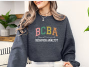 BCBA - Board Certified Behavior Analyst College Style Sweatshirt-Neurodiversity, ADHD & Autism Awareness & Acceptance Sweatshirt by Daily Bloom