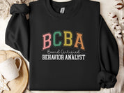 BCBA - Board Certified Behavior Analyst College Style Sweatshirt-Black-Neurodiversity, ADHD & Autism Awareness & Acceptance Sweatshirt by Daily Bloom