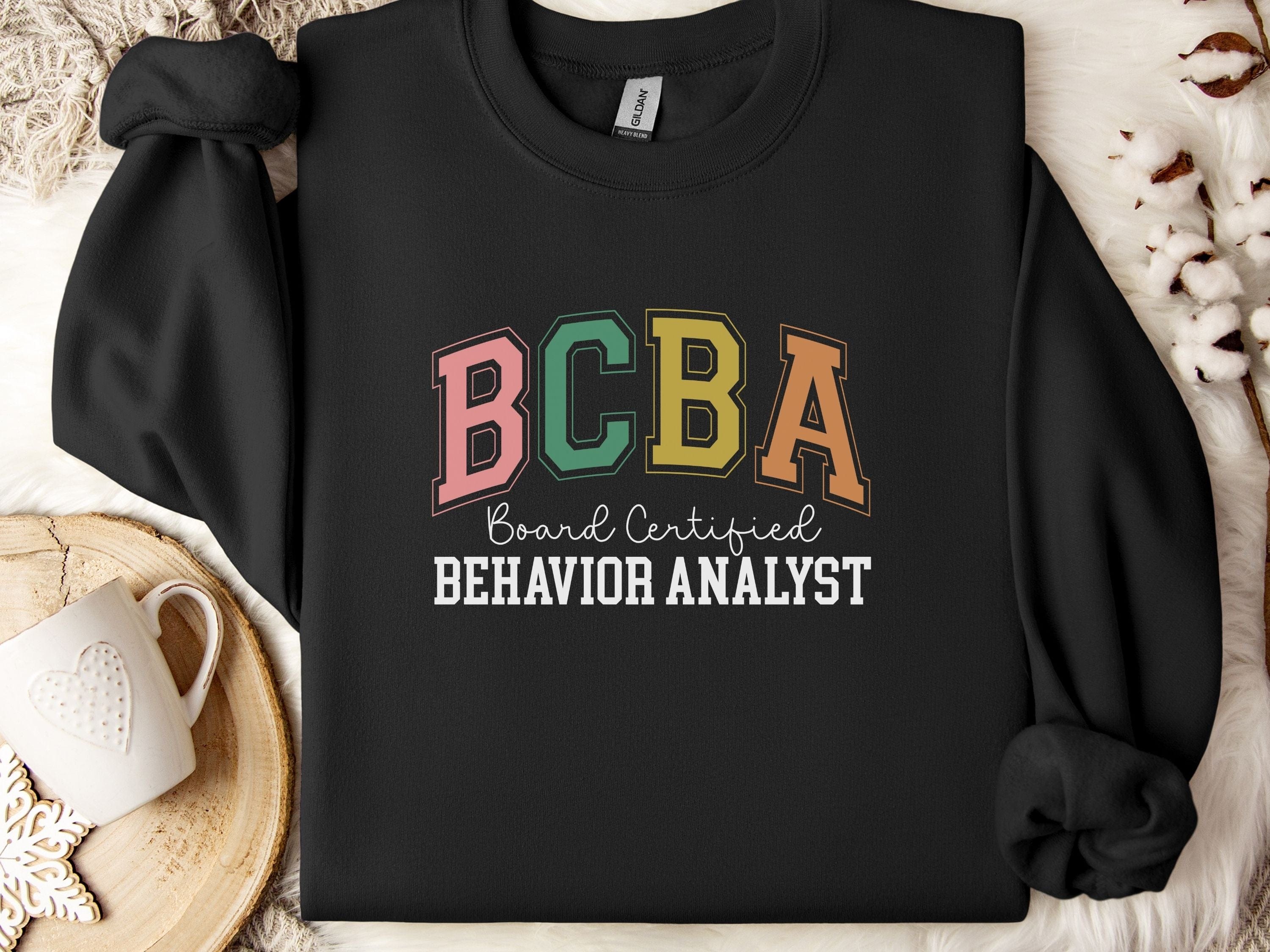 BCBA - Board Certified Behavior Analyst College Style Sweatshirt-Black-Neurodiversity, ADHD & Autism Awareness & Acceptance Sweatshirt by Daily Bloom
