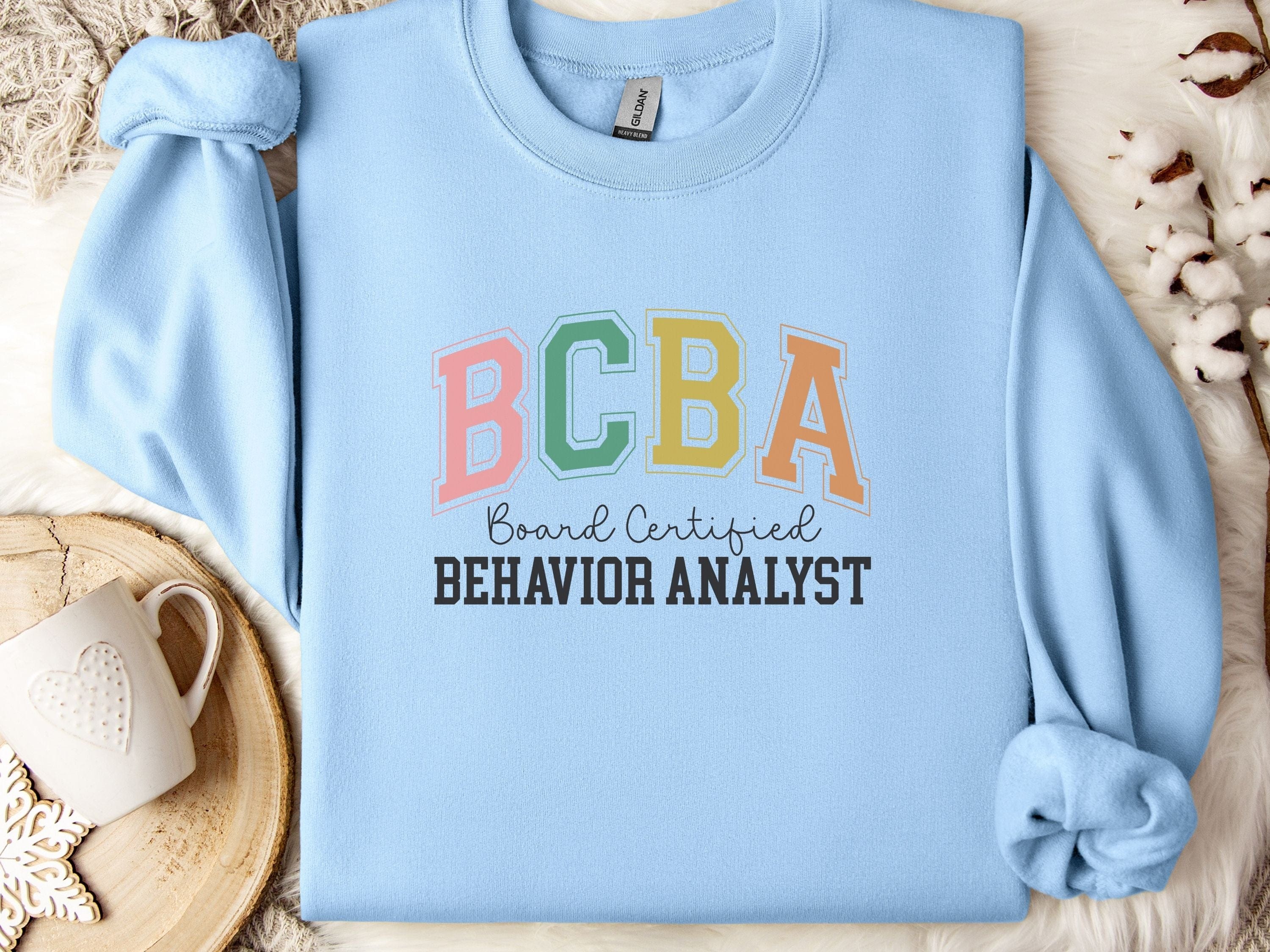 BCBA - Board Certified Behavior Analyst College Style Sweatshirt-Light Blue-Neurodiversity, ADHD & Autism Awareness & Acceptance Sweatshirt by Daily Bloom