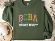 BCBA - Board Certified Behavior Analyst College Style Sweatshirt-Military Green-Neurodiversity, ADHD & Autism Awareness & Acceptance Sweatshirt by Daily Bloom