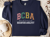BCBA - Board Certified Behavior Analyst College Style Sweatshirt-Navy-Neurodiversity, ADHD & Autism Awareness & Acceptance Sweatshirt by Daily Bloom