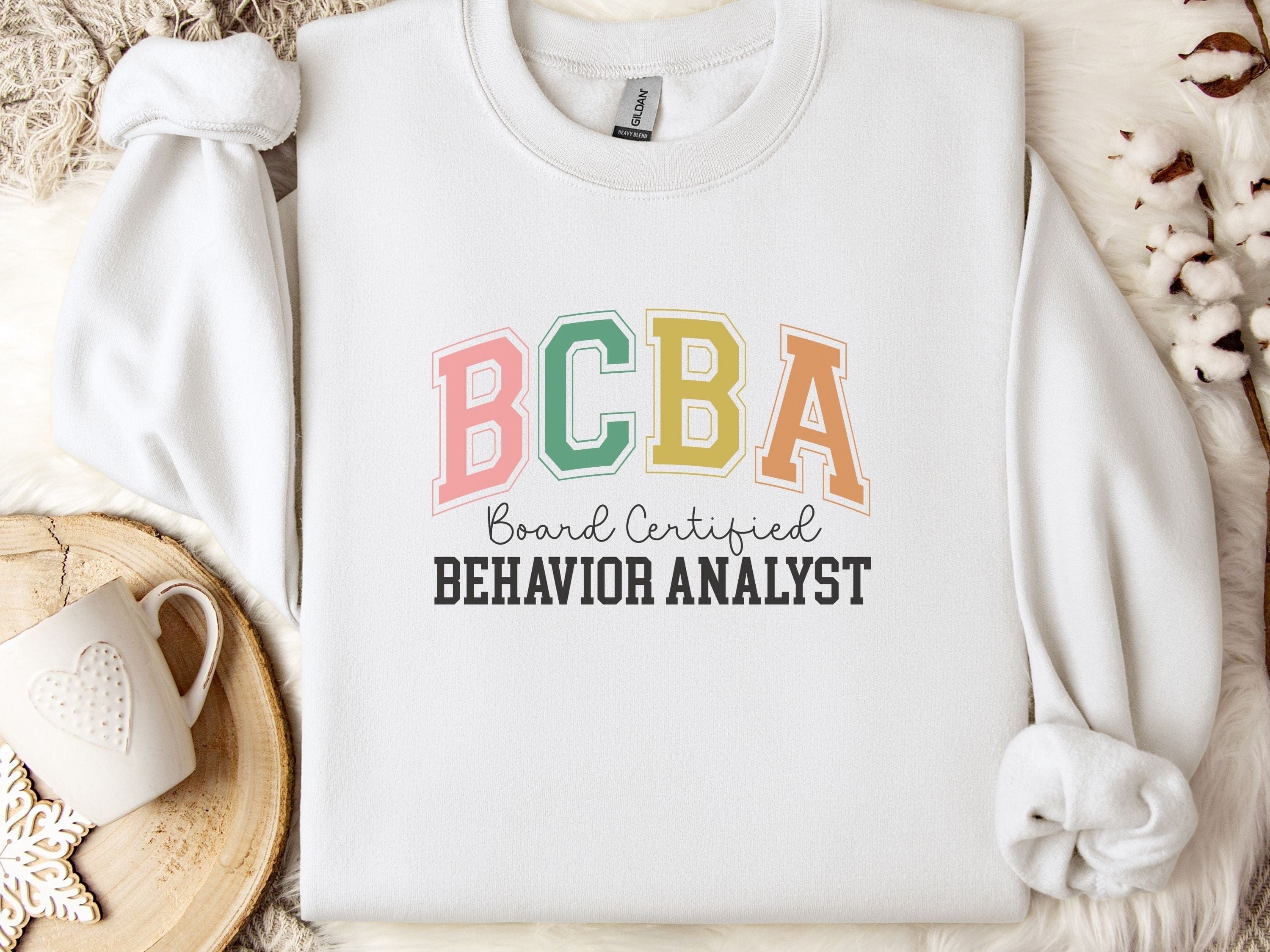 BCBA - Board Certified Behavior Analyst College Style Sweatshirt-White-Neurodiversity, ADHD & Autism Awareness & Acceptance Sweatshirt by Daily Bloom