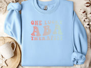 One Lucky ABA Therapist Sweatshirt-Light Blue-Neurodiversity, ADHD & Autism Awareness & Acceptance Sweatshirt by Daily Bloom