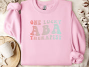 One Lucky ABA Therapist Sweatshirt-Light Pink-Neurodiversity, ADHD & Autism Awareness & Acceptance Sweatshirt by Daily Bloom