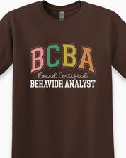 BCBA - Board Certified Behavior Analyst College Style Tee-Neurodiversity, ADHD & Autism Awareness & Acceptance T-Shirt by Daily Bloom
