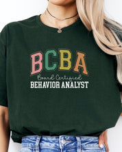 BCBA - Board Certified Behavior Analyst College Style Tee-Neurodiversity, ADHD & Autism Awareness & Acceptance T-Shirt by Daily Bloom