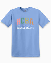 BCBA - Board Certified Behavior Analyst College Style Tee-Carolina Blue-Neurodiversity, ADHD & Autism Awareness & Acceptance T-Shirt by Daily Bloom