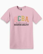BCBA - Board Certified Behavior Analyst College Style Tee-Light Pink-Neurodiversity, ADHD & Autism Awareness & Acceptance T-Shirt by Daily Bloom