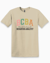 BCBA - Board Certified Behavior Analyst College Style Tee-Sand-Neurodiversity, ADHD & Autism Awareness & Acceptance T-Shirt by Daily Bloom