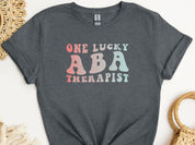 One Lucky ABA Therapist Tee-Dark Heather Grey-Neurodiversity, ADHD & Autism Awareness & Acceptance T-Shirt by Daily Bloom