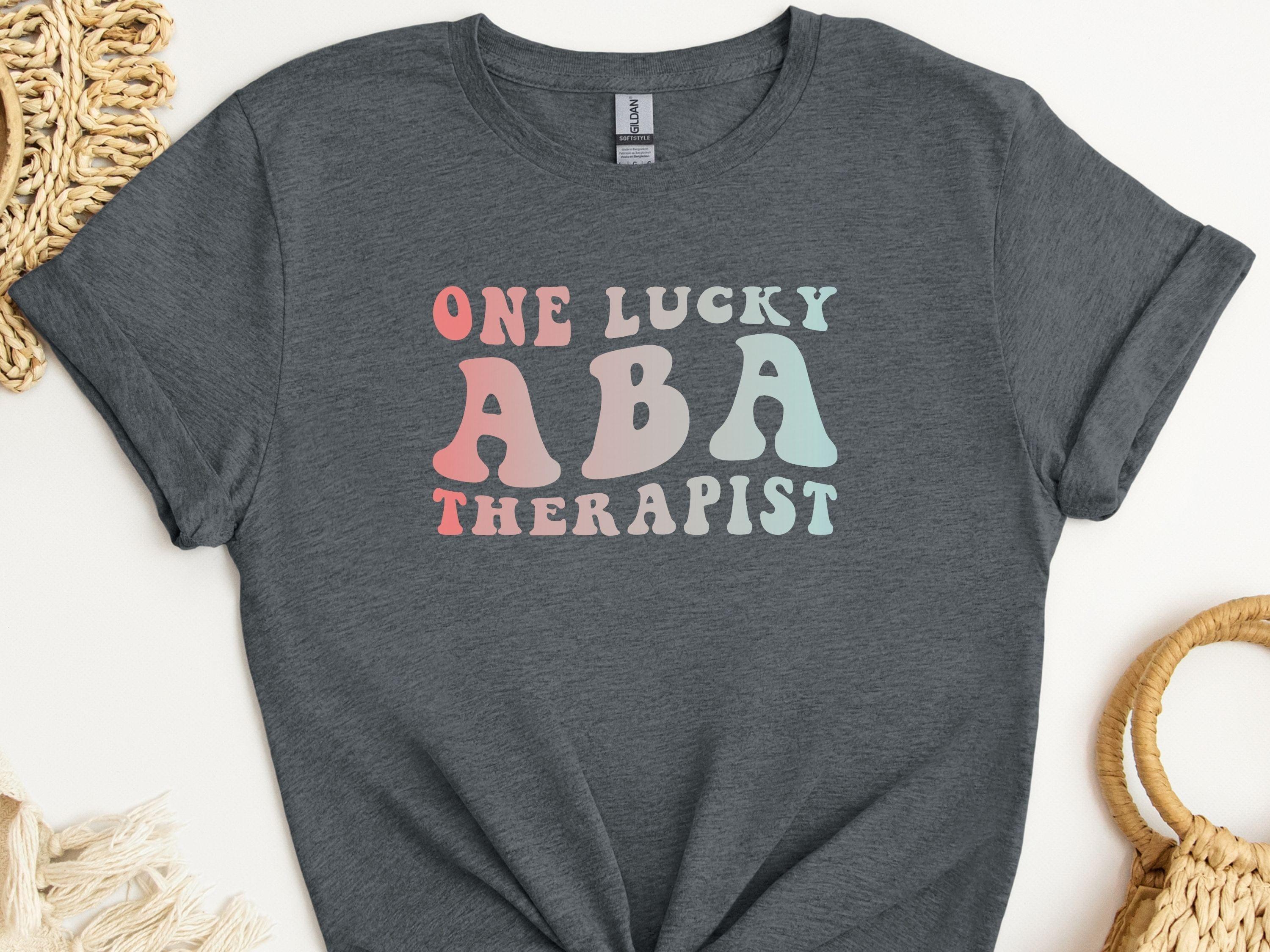 One Lucky ABA Therapist Tee-Dark Heather Grey-Neurodiversity, ADHD & Autism Awareness & Acceptance T-Shirt by Daily Bloom