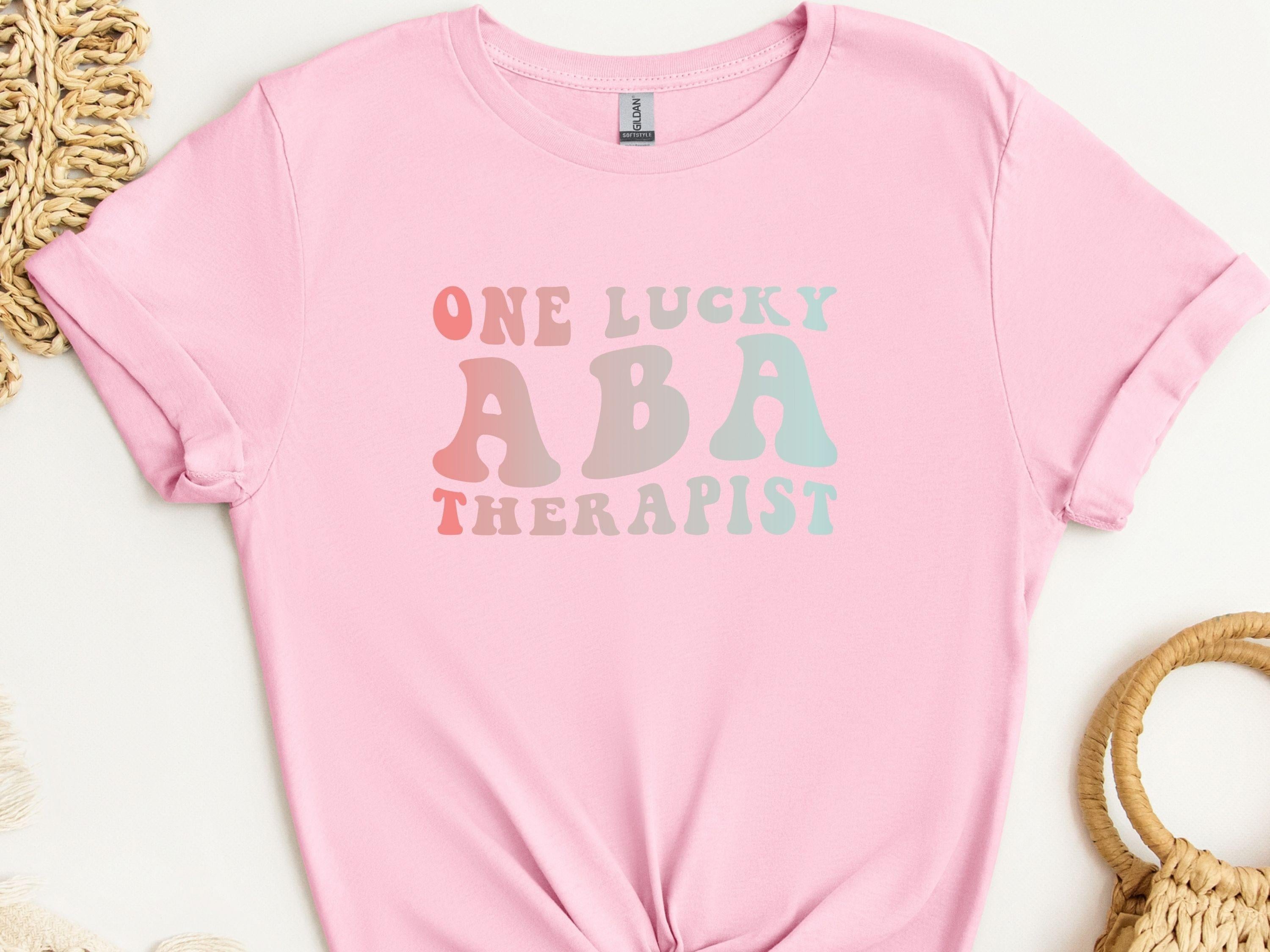 One Lucky ABA Therapist Tee-Light Pink-Neurodiversity, ADHD & Autism Awareness & Acceptance T-Shirt by Daily Bloom