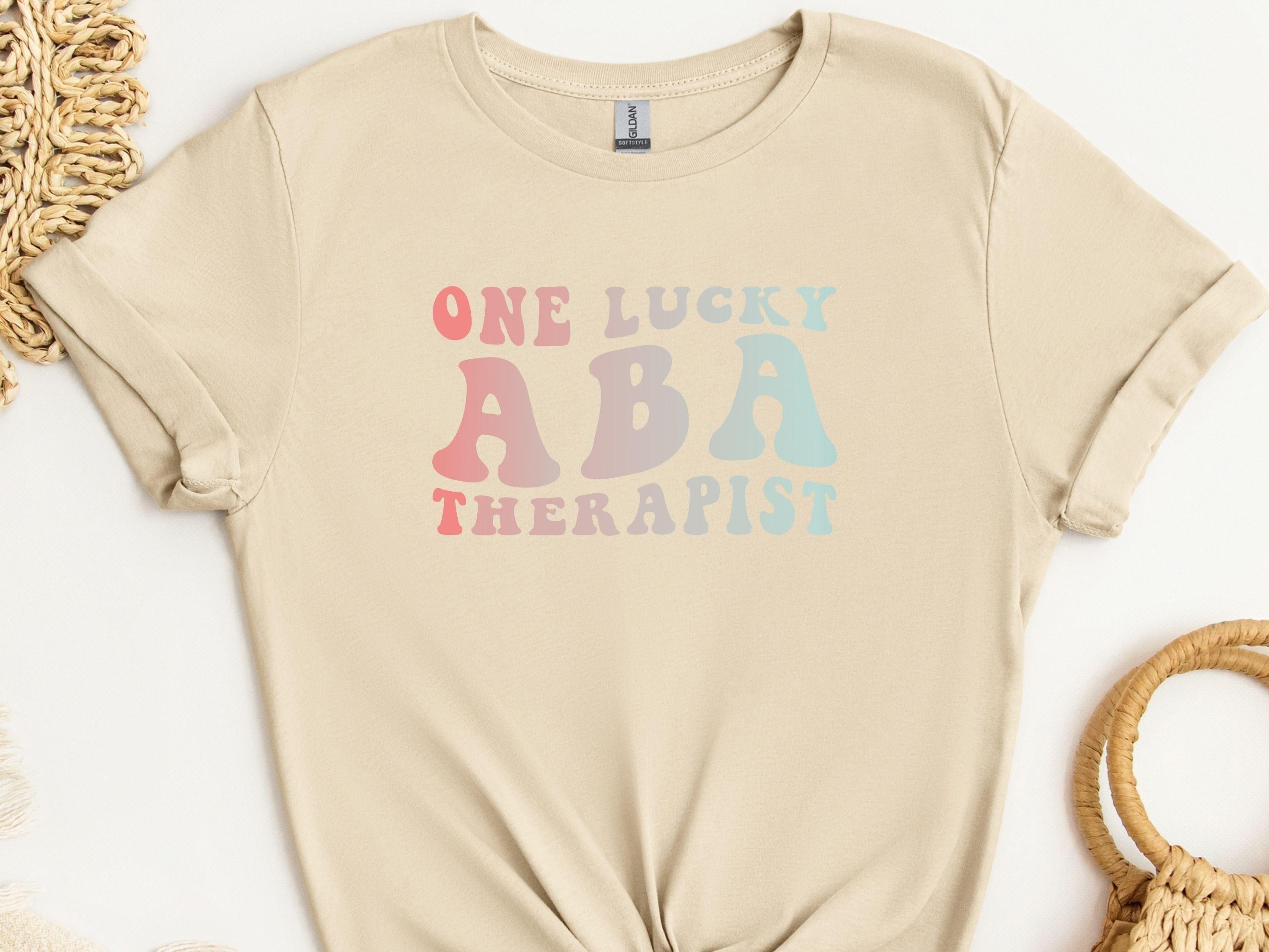 One Lucky ABA Therapist Tee-Sand-Neurodiversity, ADHD & Autism Awareness & Acceptance T-Shirt by Daily Bloom