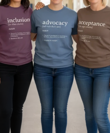 Three teachers in school hallway wearing Daily Bloom definition t-shirts featuring inclusion, advocacy, and acceptance designs